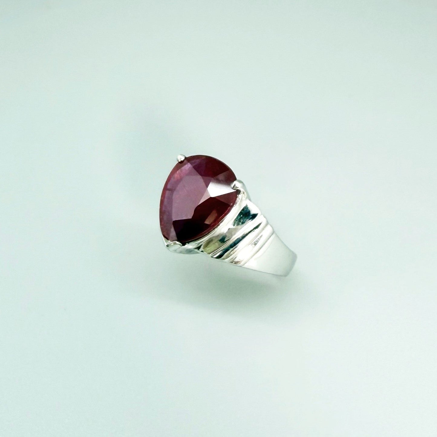 Ruby solitaire ring in white gold plated sterling silver, featuring a natural deep red gemstone, elegant and timeless design.