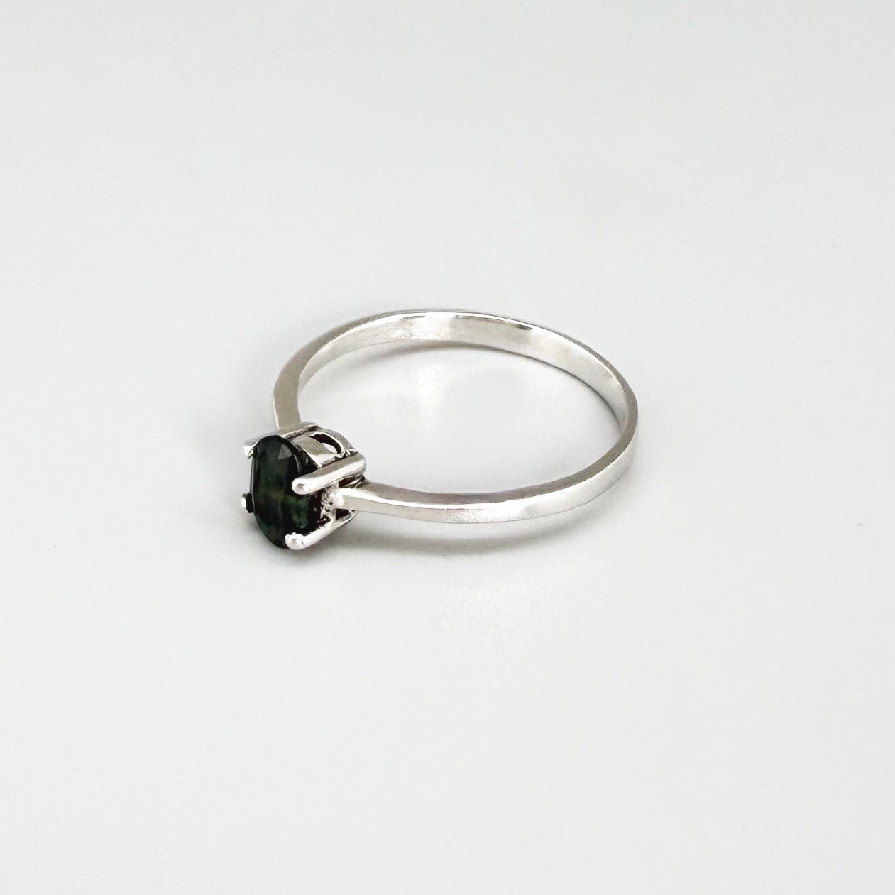 Sapphire solitaire ring in white gold plated sterling silver, featuring a natural deep blue gemstone, elegant and timeless design.
