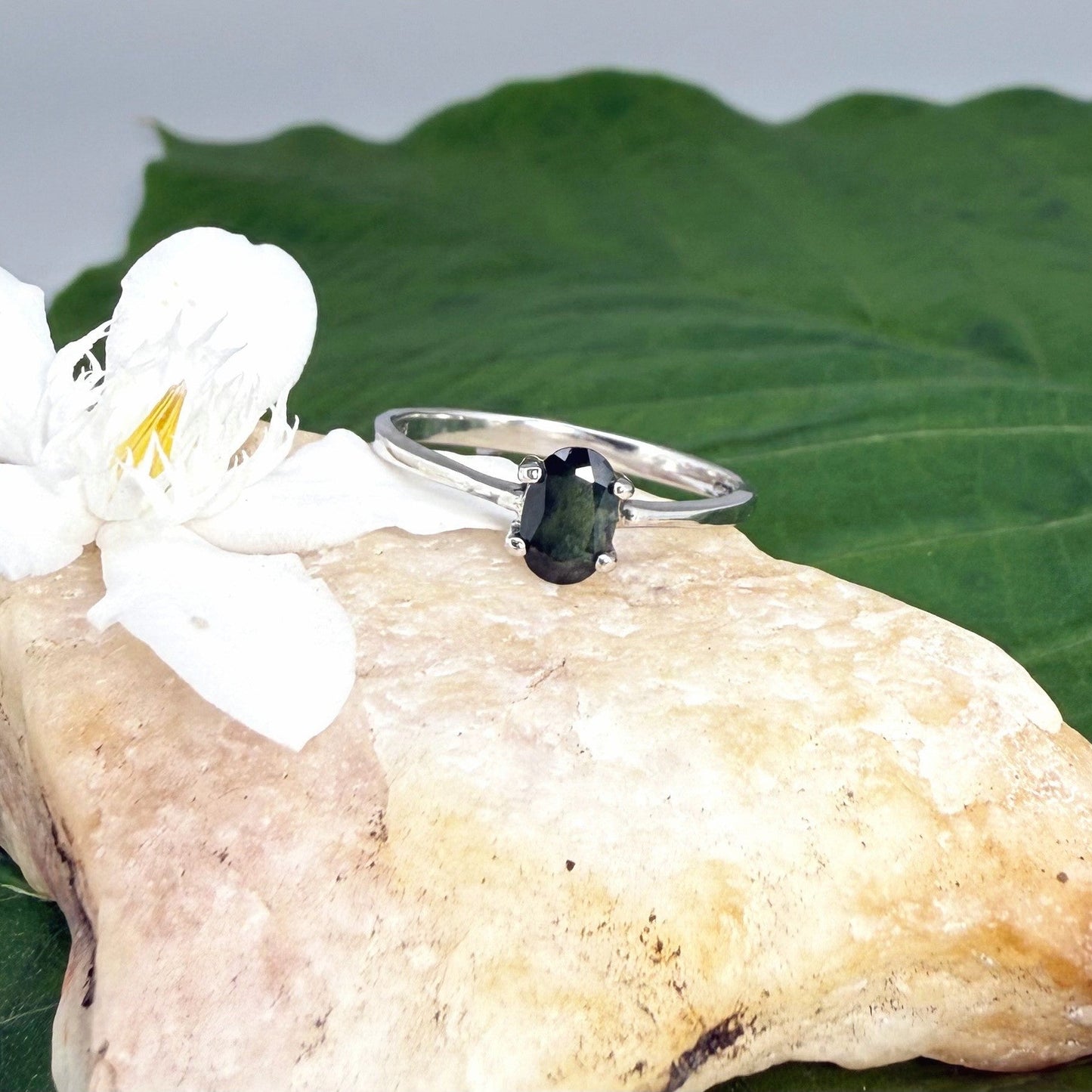 Sapphire solitaire ring in white gold plated sterling silver, featuring a natural deep blue gemstone, elegant and timeless design.