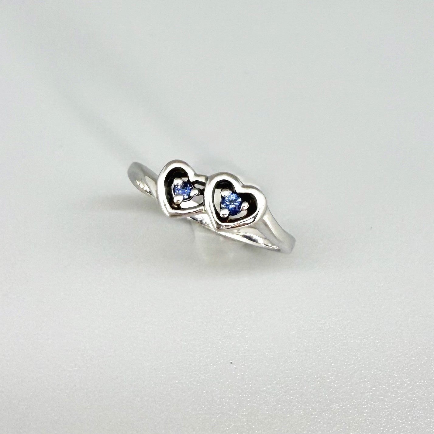 Delicate sapphire ring in white gold plated sterling silver, featuring natural blue gemstones in a graceful setting, elegant and timeless design.