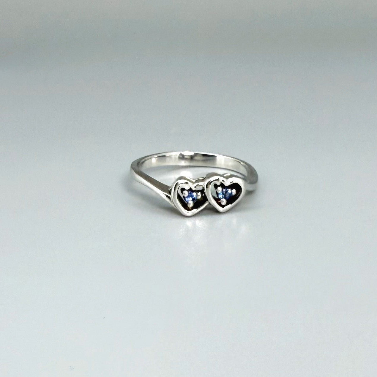 Delicate sapphire ring in white gold plated sterling silver, featuring natural blue gemstones in a graceful setting, elegant and timeless design.