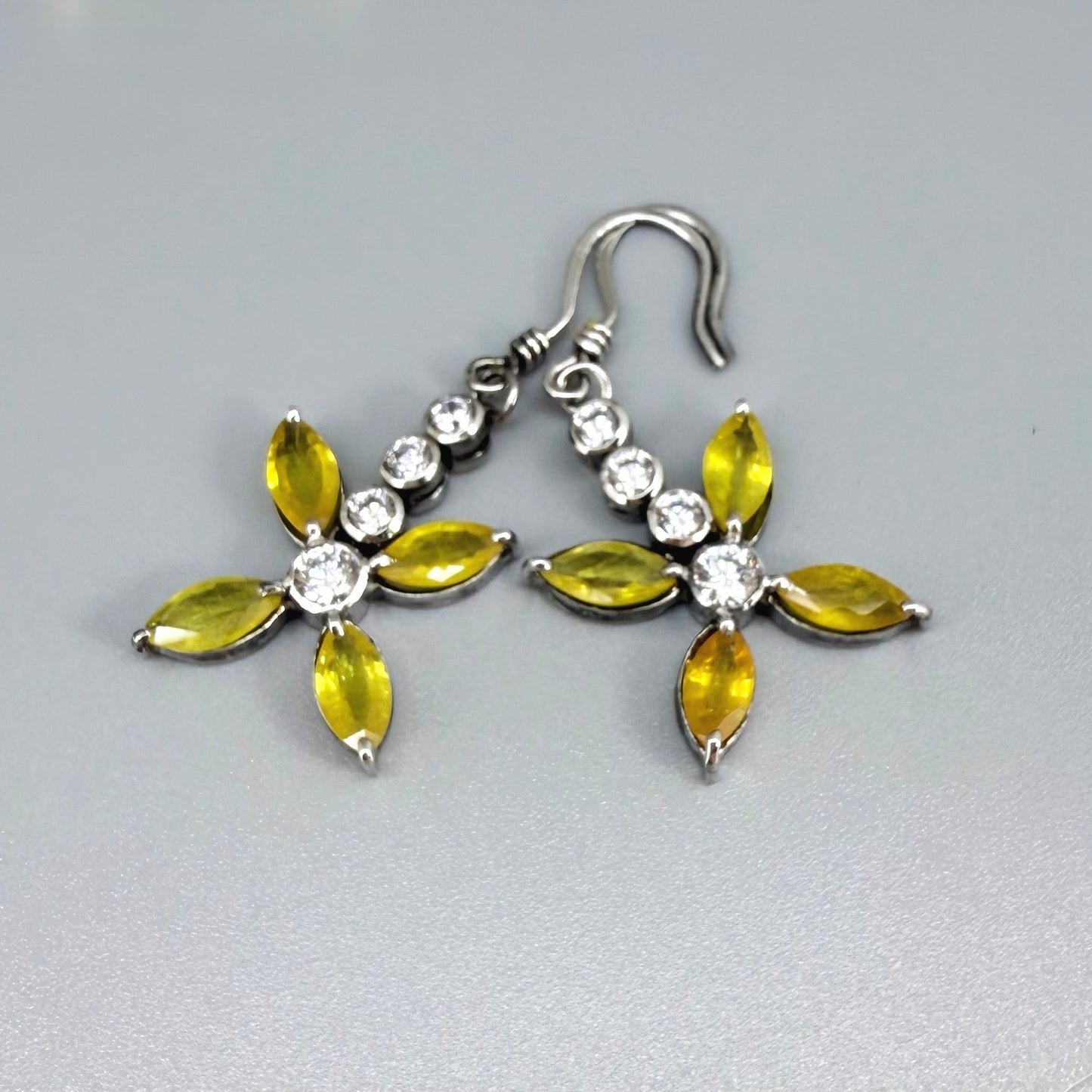Sterling silver drop earrings with yellow sapphires and cubic zirconia in a floral design, linked to the Sapphire Jewelry Collection.