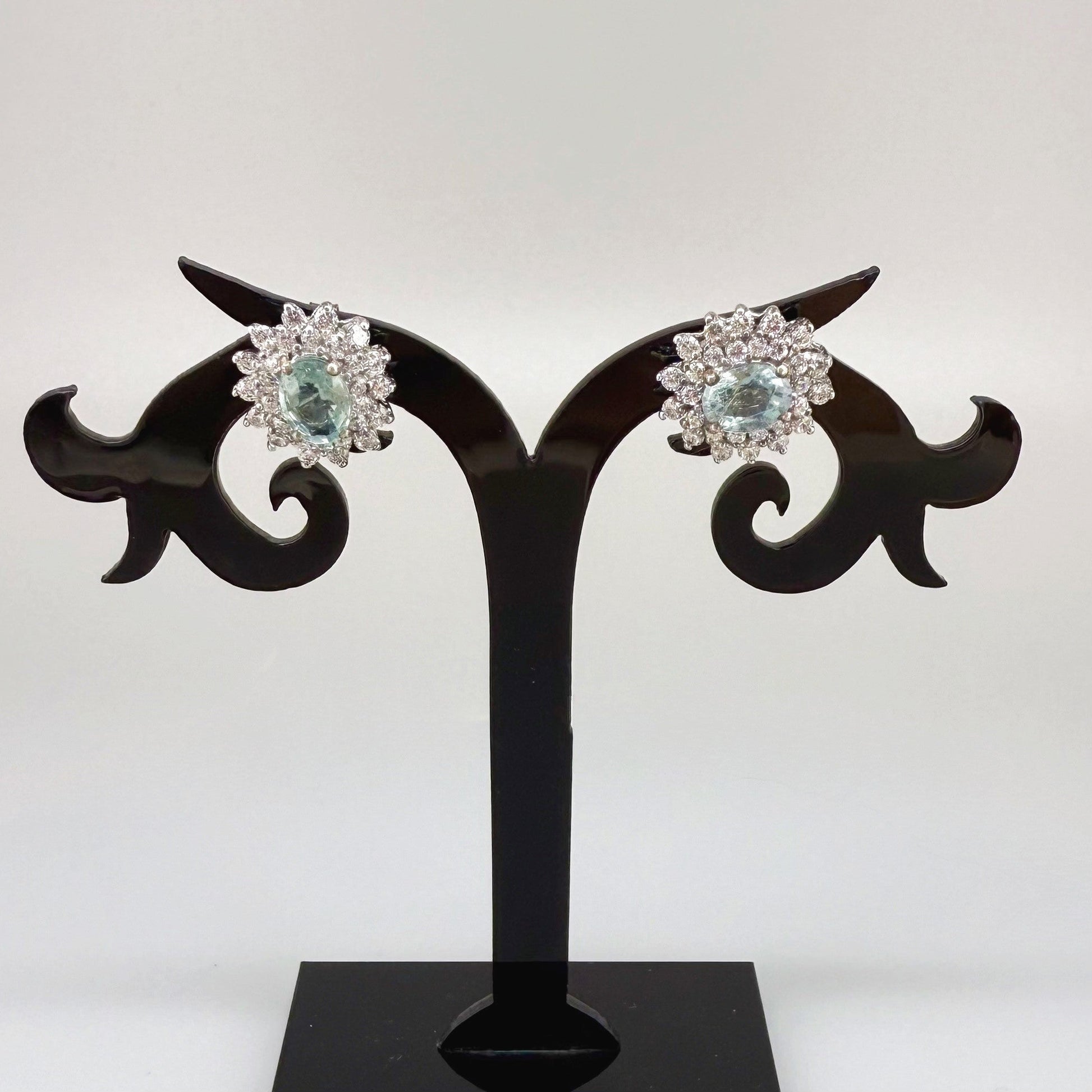 Aquamarine and cubic zirconia stud earrings in white gold plated sterling silver with butterfly backs.
