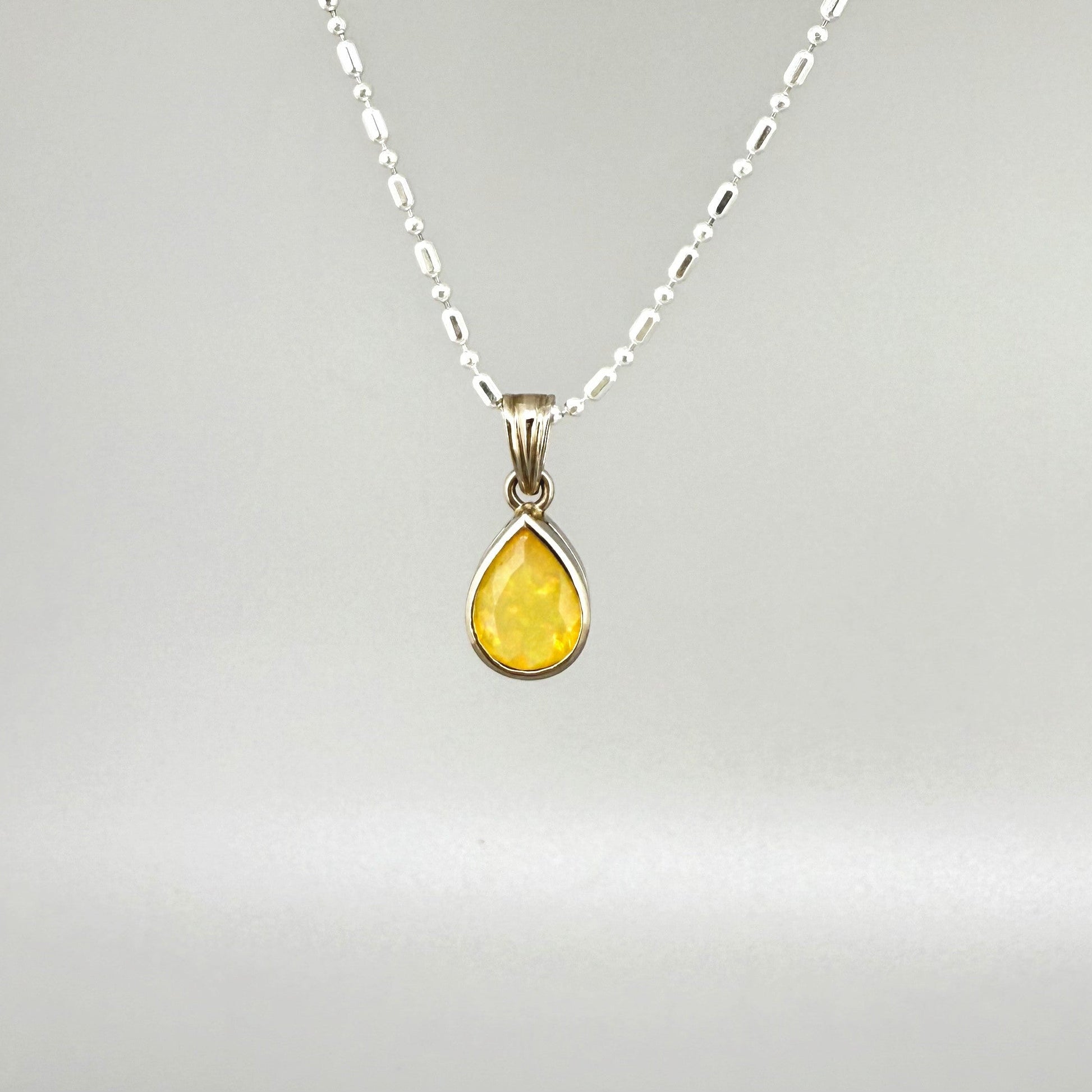 Handmade white gold plated silver pendant with 14.76 ct rose quartz and cubic zirconia accents, elegant and refined design.