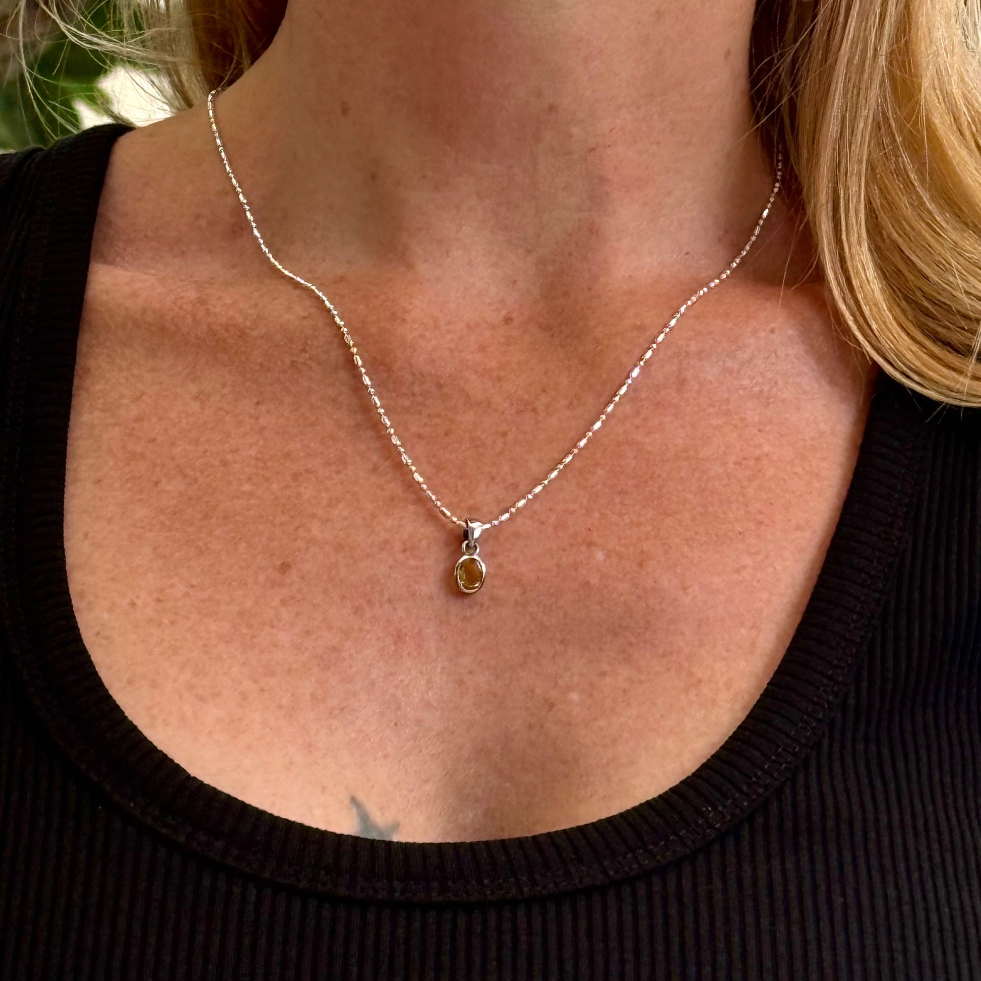 Handcrafted three-pendant gemstone necklace with sapphires, ruby, spinel, and tsavorite (5.81 ct total) on a black leather cord — modular design in white-gold-plated silver.