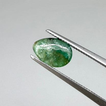 1.42 ct natural untreated emerald from Zambia, one side polished and the other cabochon-shaped.