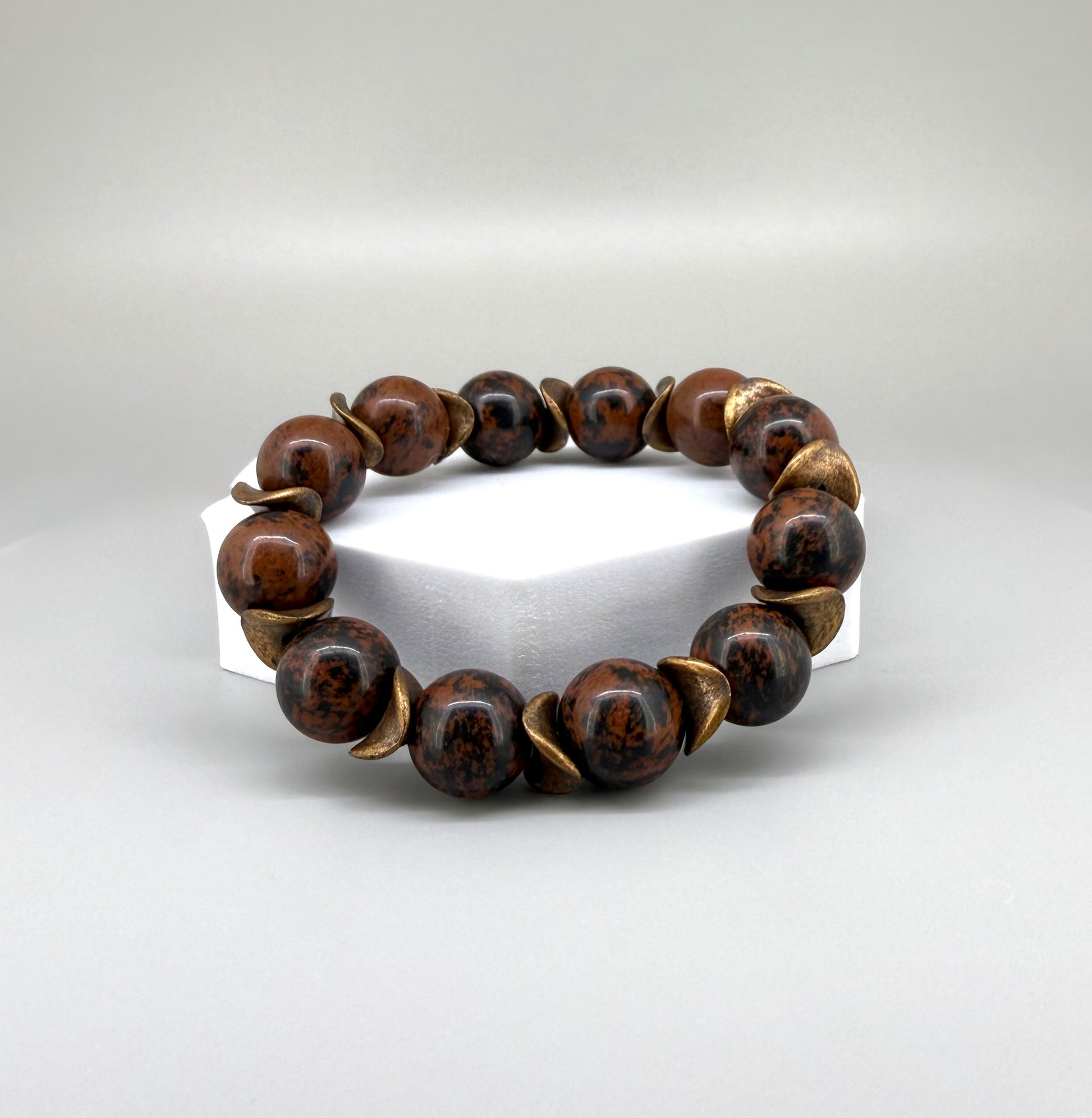 Mahogany obsidian beaded bracelet, 17cm, natural brown and black gemstone beads with copper-colored spacer accents on elastic stretch band.