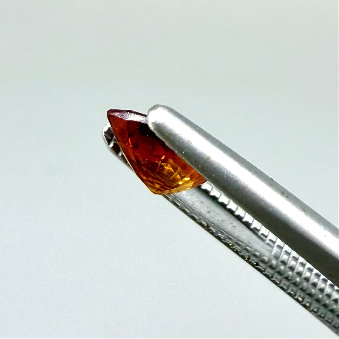 0.5 ct natural fiery-orange spessartine garnet from Namibia, pear cut.