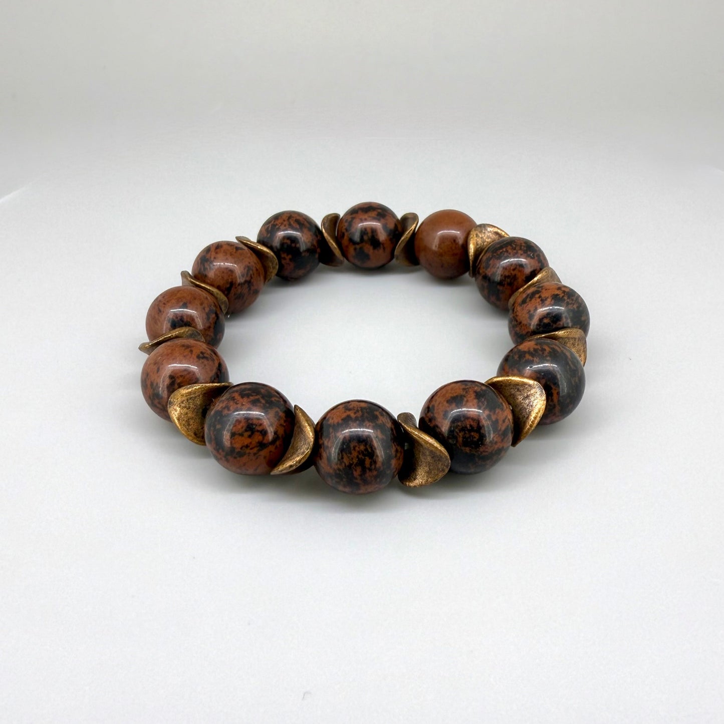 Mahogany obsidian beaded bracelet, 17cm, natural brown and black gemstone beads with copper-colored spacer accents on elastic stretch band.
