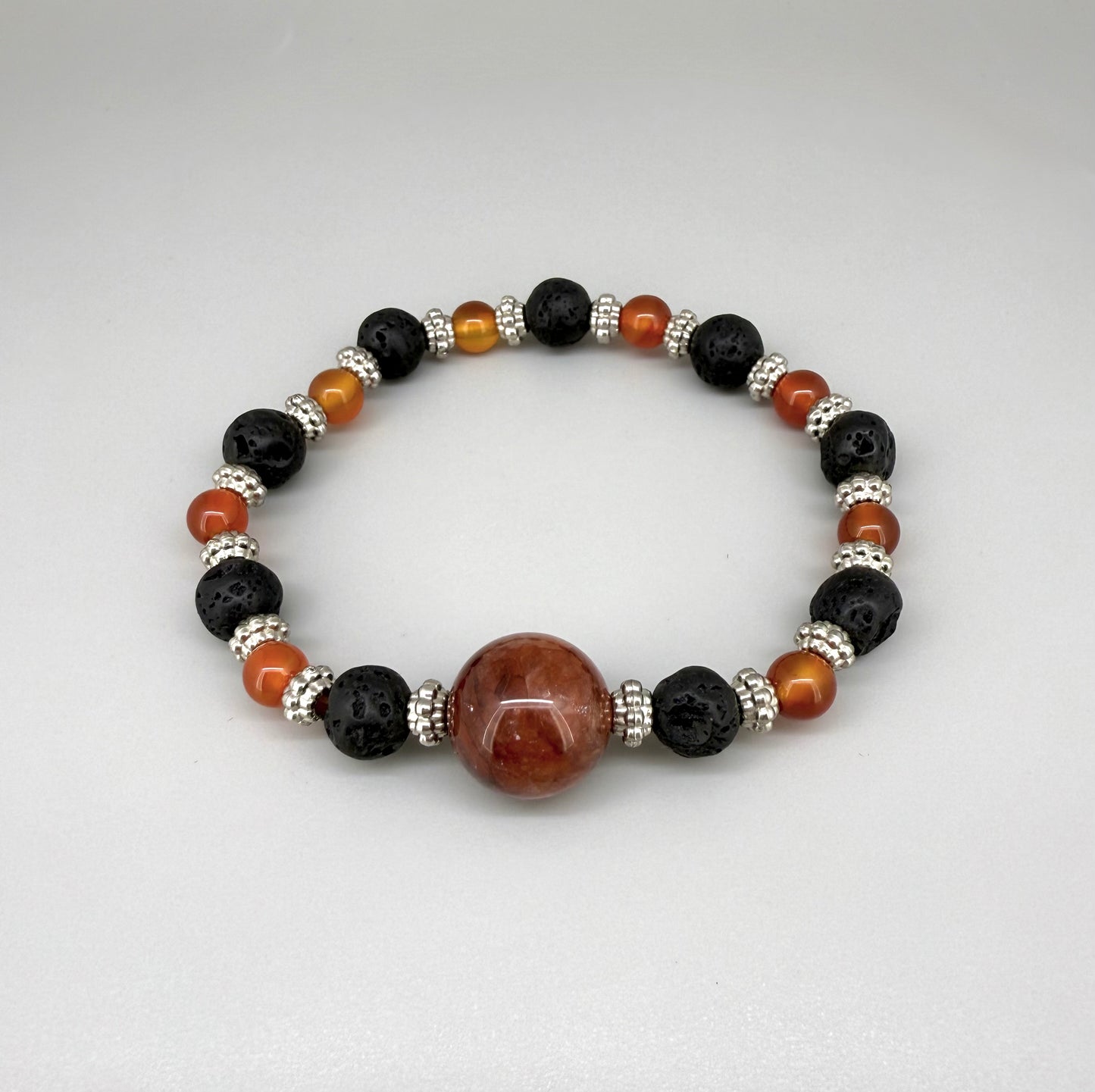 Alt-Text

Carnelian, lava, and cherry quartz beaded bracelet, 18cm, natural orange-red, matte black, and pink beads on elastic stretch band.