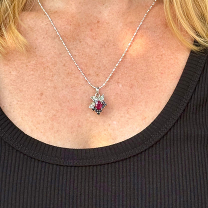 Handcrafted pendant with ruby (1.22 ct), sapphires (0.41 ct) and peridots (0.13 ct), set in white-gold-plated sterling silver.
