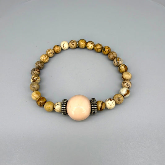 Jasper beaded bracelet, 18cm, light earthy tones with peach-colored focal bead on elastic stretch band.