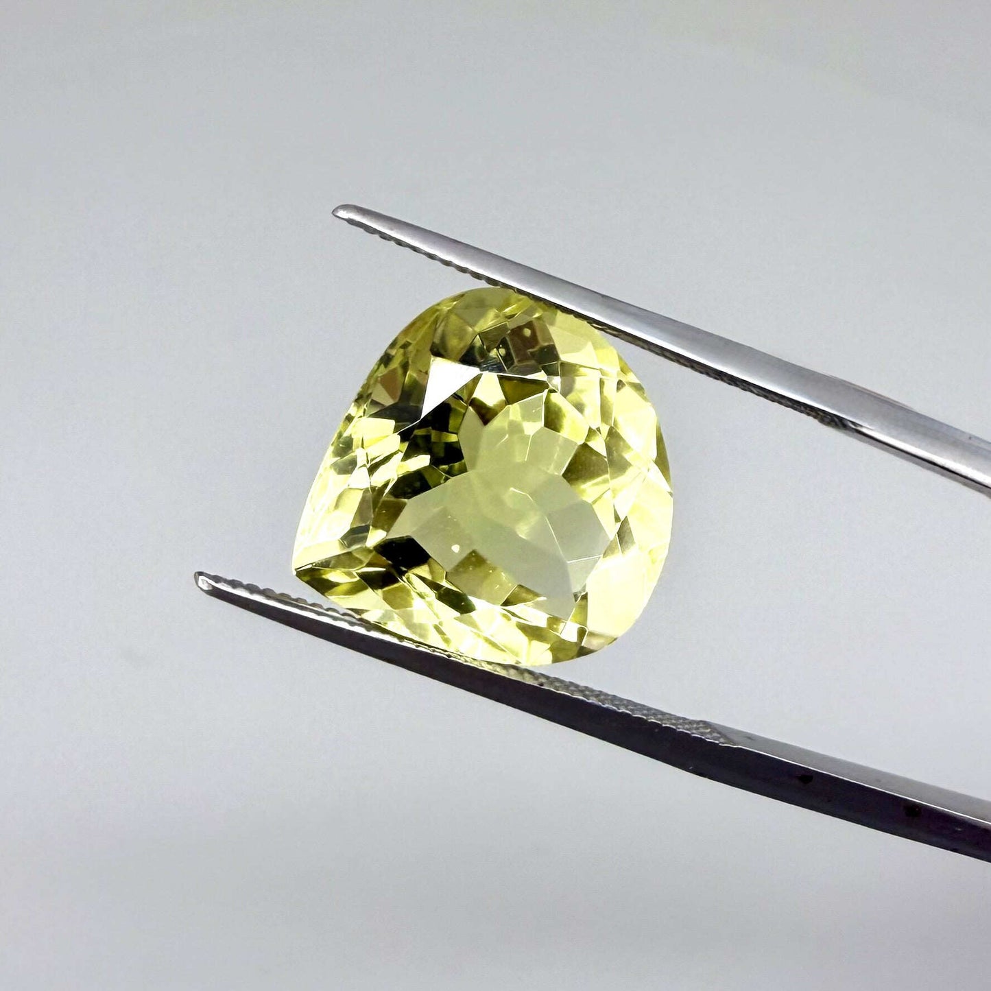 8 ct natural lemon quartz, trillion cut with bright yellow color.