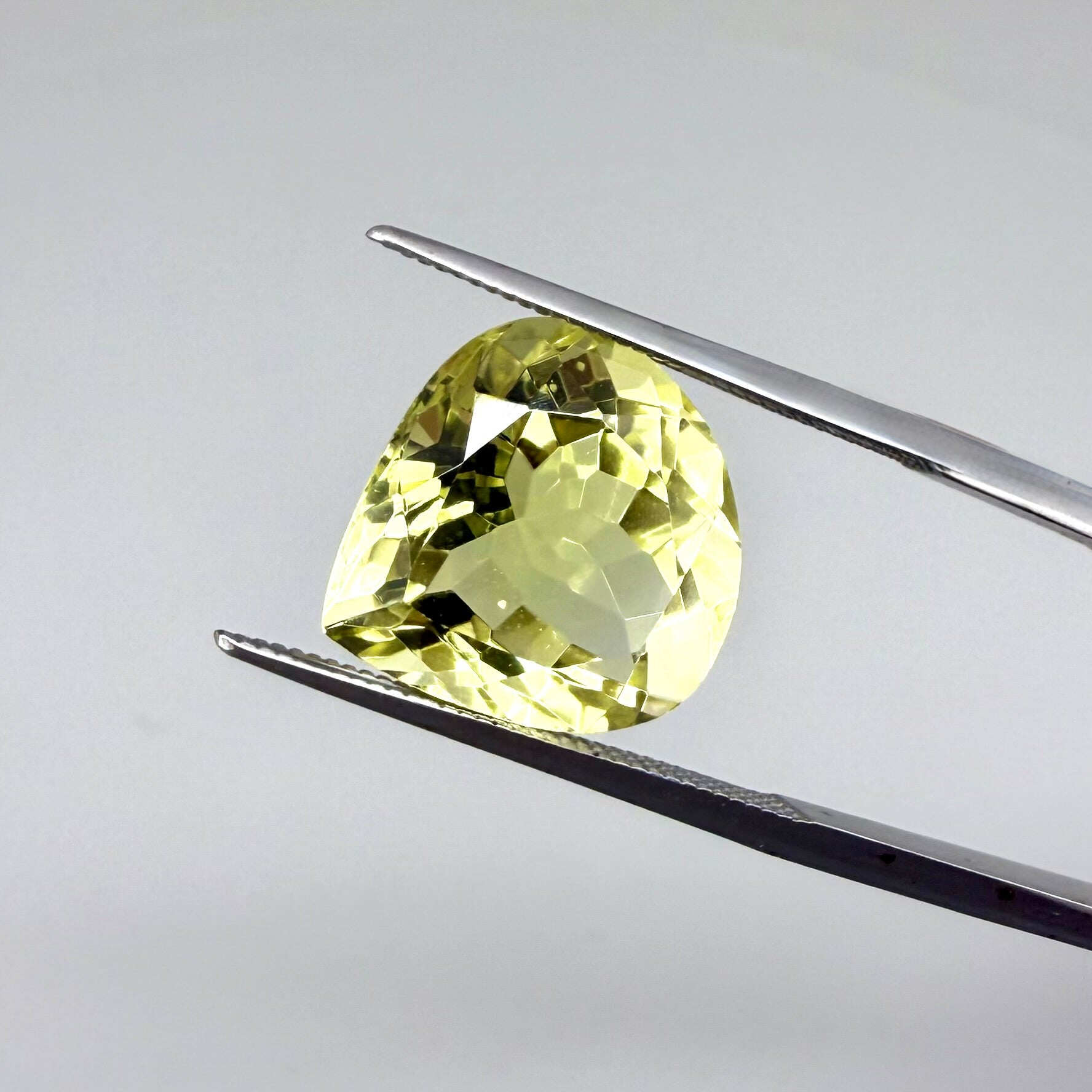8 ct natural lemon quartz, trillion cut with bright yellow color.