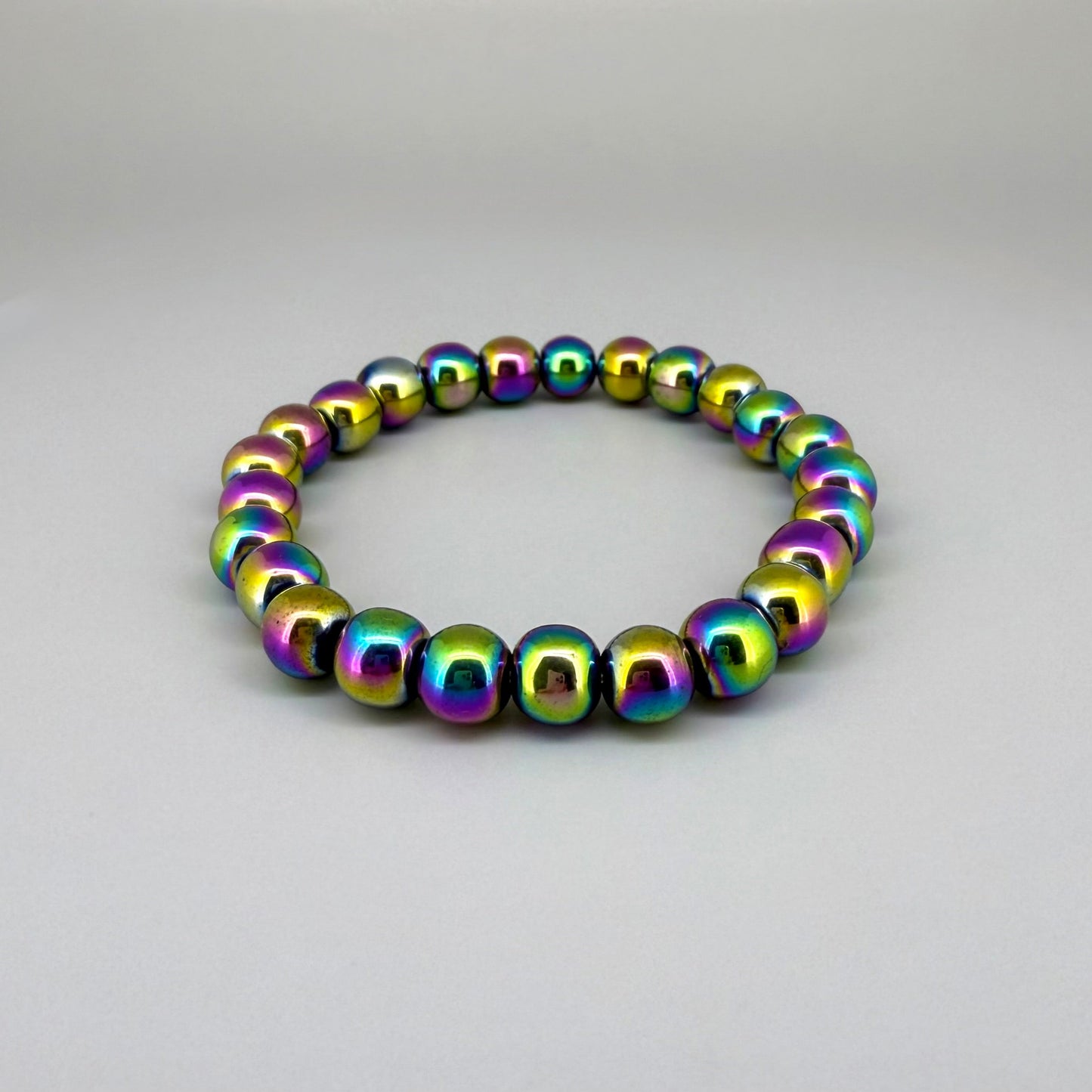 Rainbow hematite beaded bracelet, 18cm, iridescent multicolor gemstone beads on elastic stretch band.