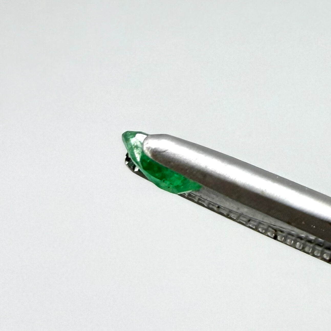 0.18 ct natural untreated Zambian emerald, oval faceted with bright bluish-green color.