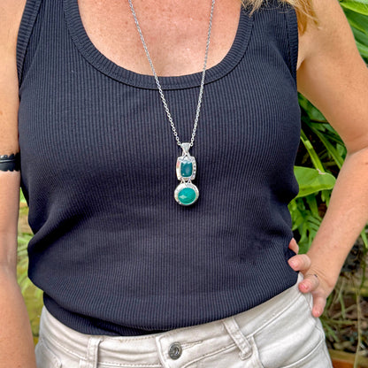 Handcrafted white-gold-plated silver pendant with two green chalcedony stones (16.47 ct total) in a modern geometric design.