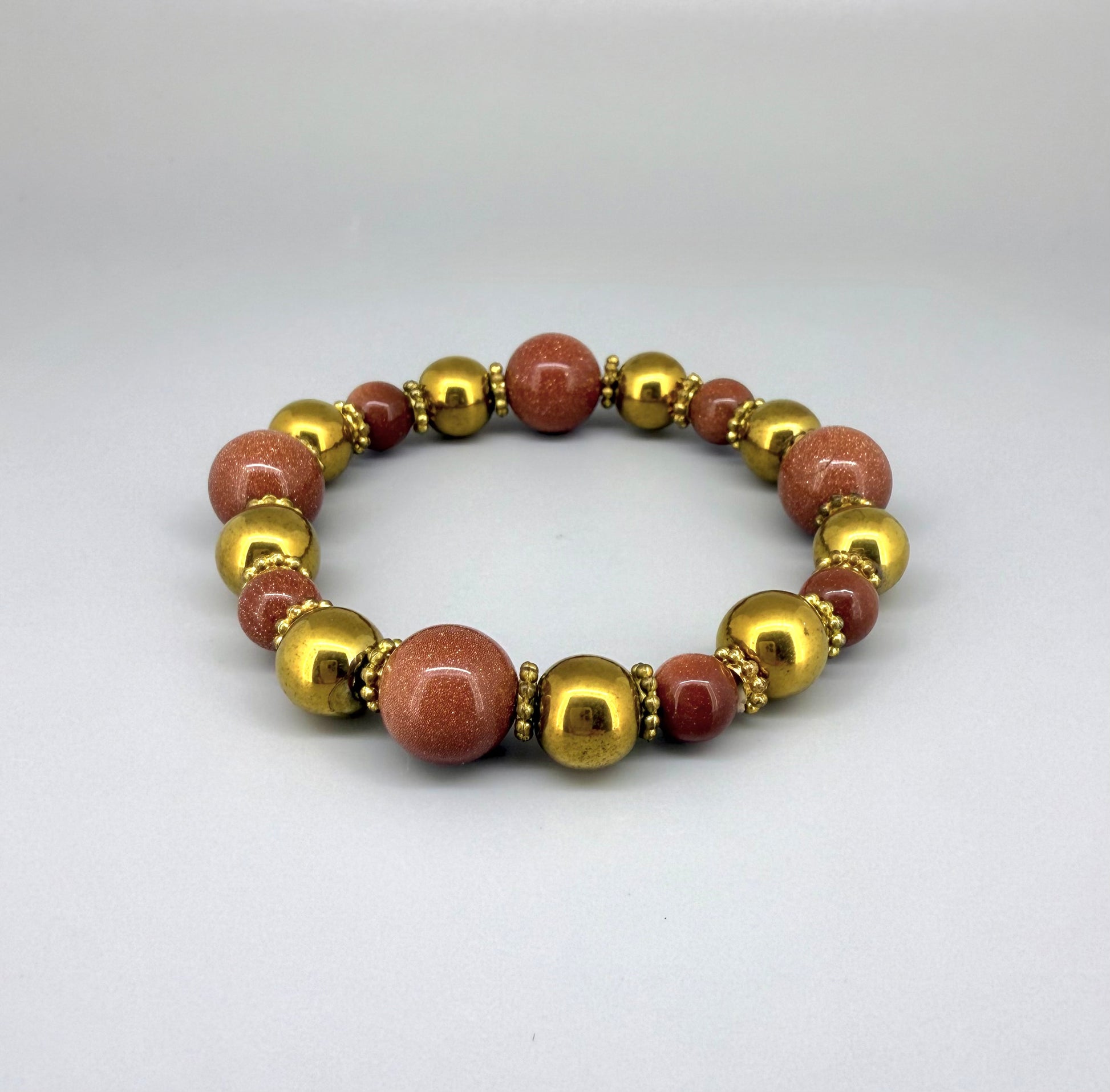 Hematite and goldstone beaded bracelet, 18cm, metallic gold and shimmering golden-copper beads on elastic stretch band.