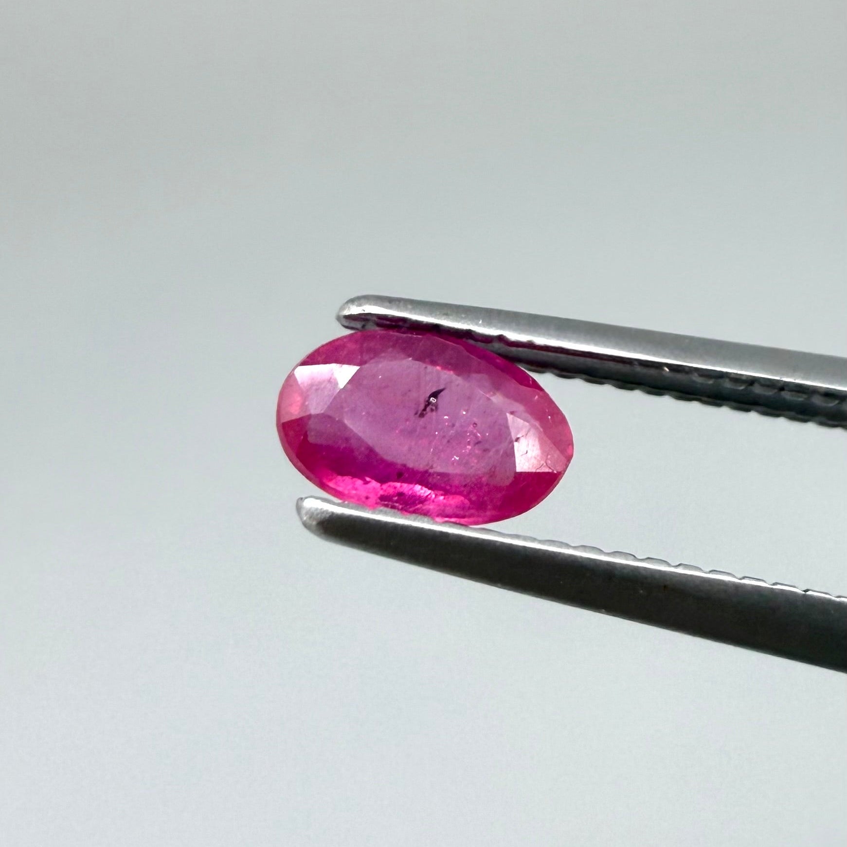 0.32 ct natural pink-red Songea ruby, oval cut.