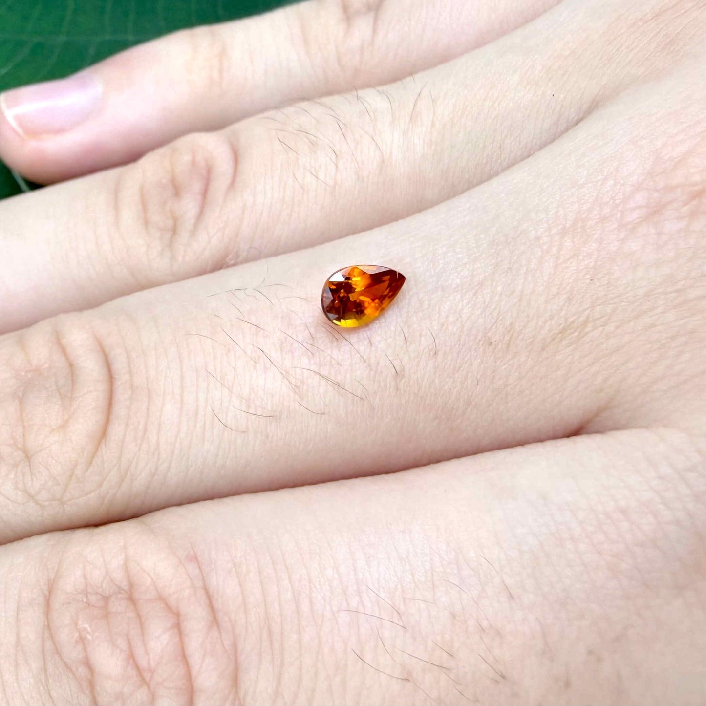 0.5 ct natural fiery-orange spessartine garnet from Namibia, pear cut.