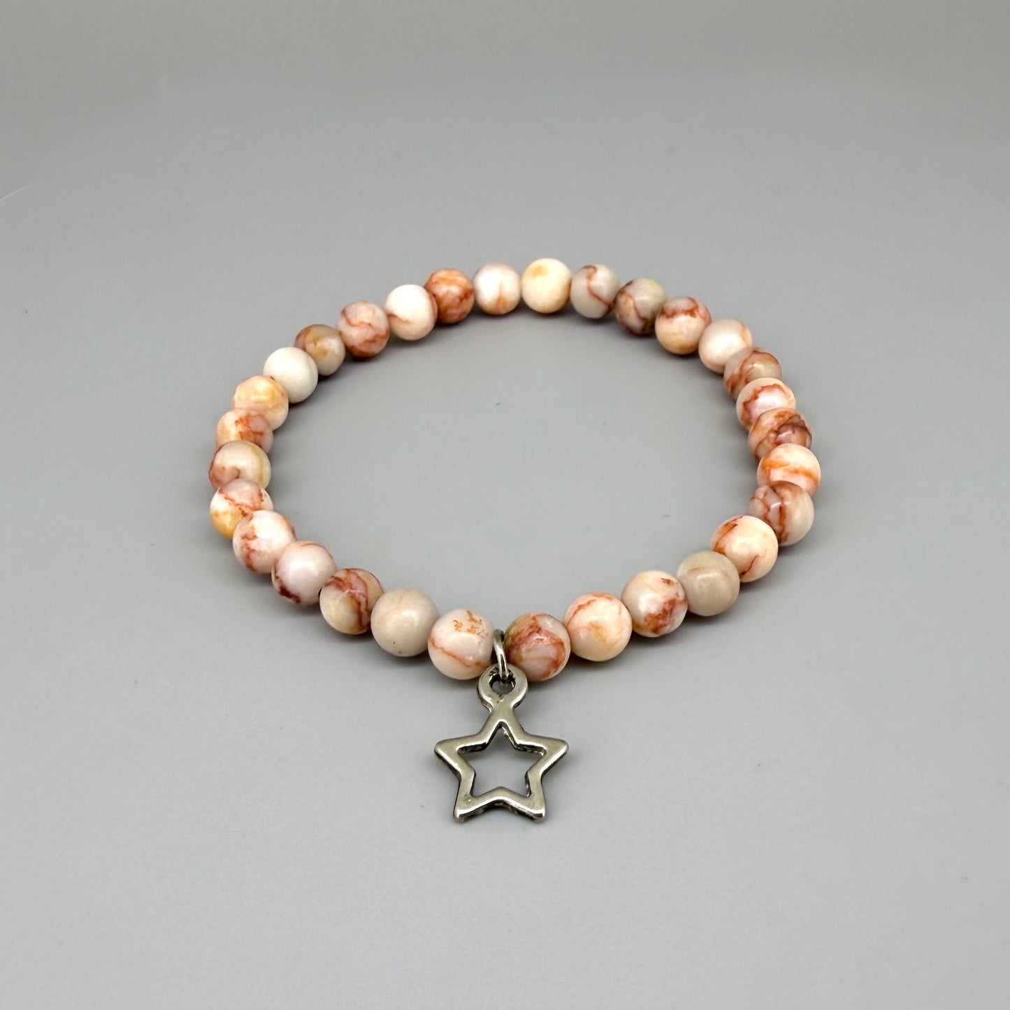 Orange-beige jasper beaded bracelet, 17cm, natural gemstone beads with star charm on elastic stretch band.