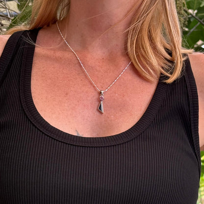 Handcrafted three-pendant gemstone necklace with sapphires, ruby, spinel, and tsavorite (5.81 ct total) on a black leather cord — modular design in white-gold-plated silver.