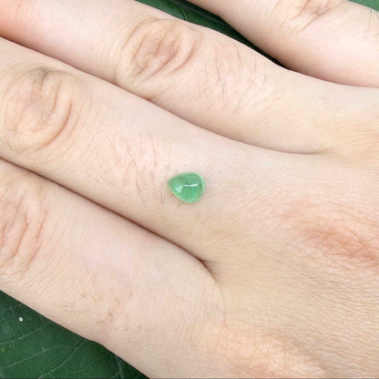 0.51 ct natural untreated emerald from Zambia, one side polished and the other cabochon-shaped.