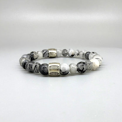 Rutilated quartz beaded bracelet, 18cm, black-white-grey gemstone beads with two decorated metal spacers on elastic band.