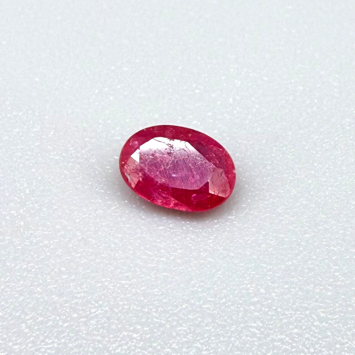 0.5 ct natural pink-red Songea ruby, oval cut.