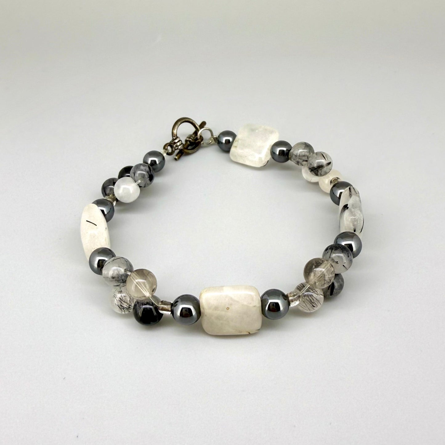 Rutilated quartz and hematite beaded bracelet, natural gemstone beads with toggle clasp.