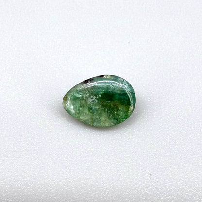 1.42 ct natural untreated emerald from Zambia, one side polished and the other cabochon-shaped.
