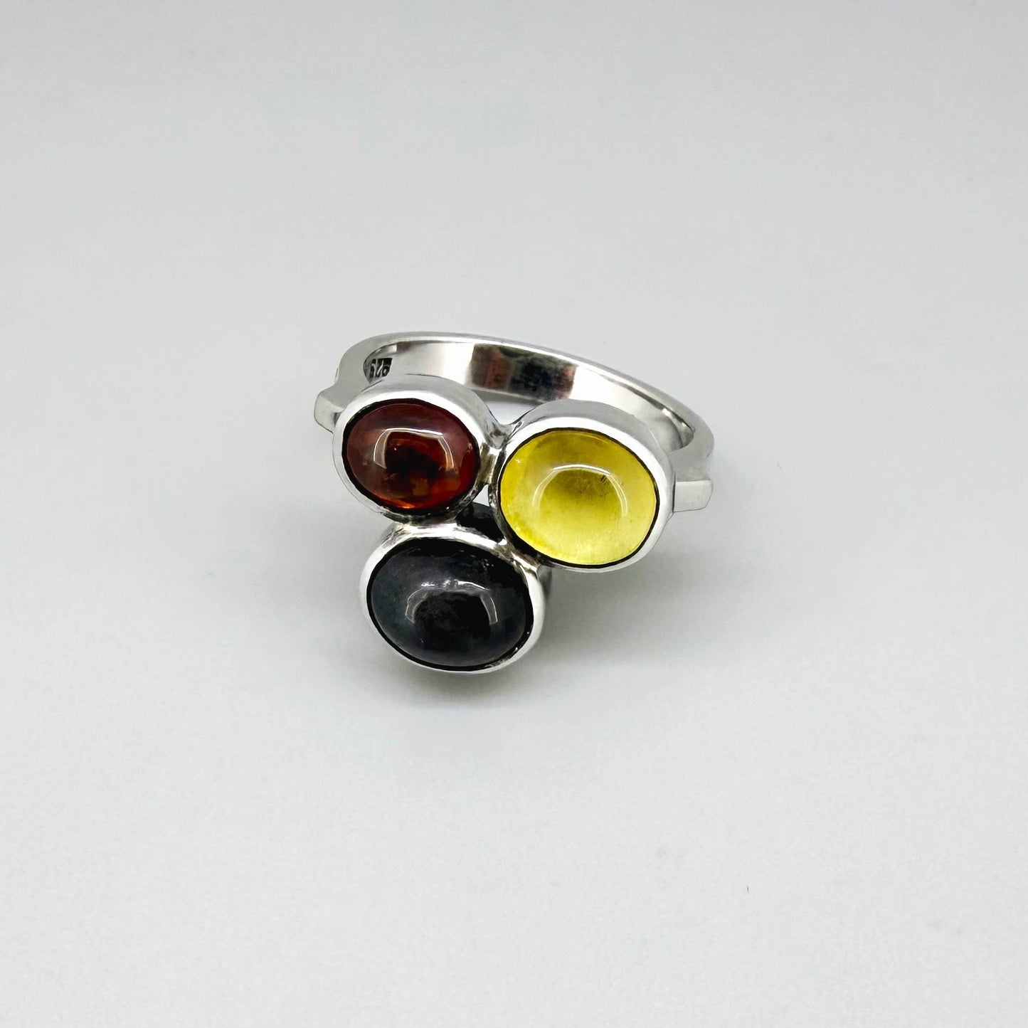 Handmade sterling silver ring with citrine, garnet and cat’s eye gemstones.