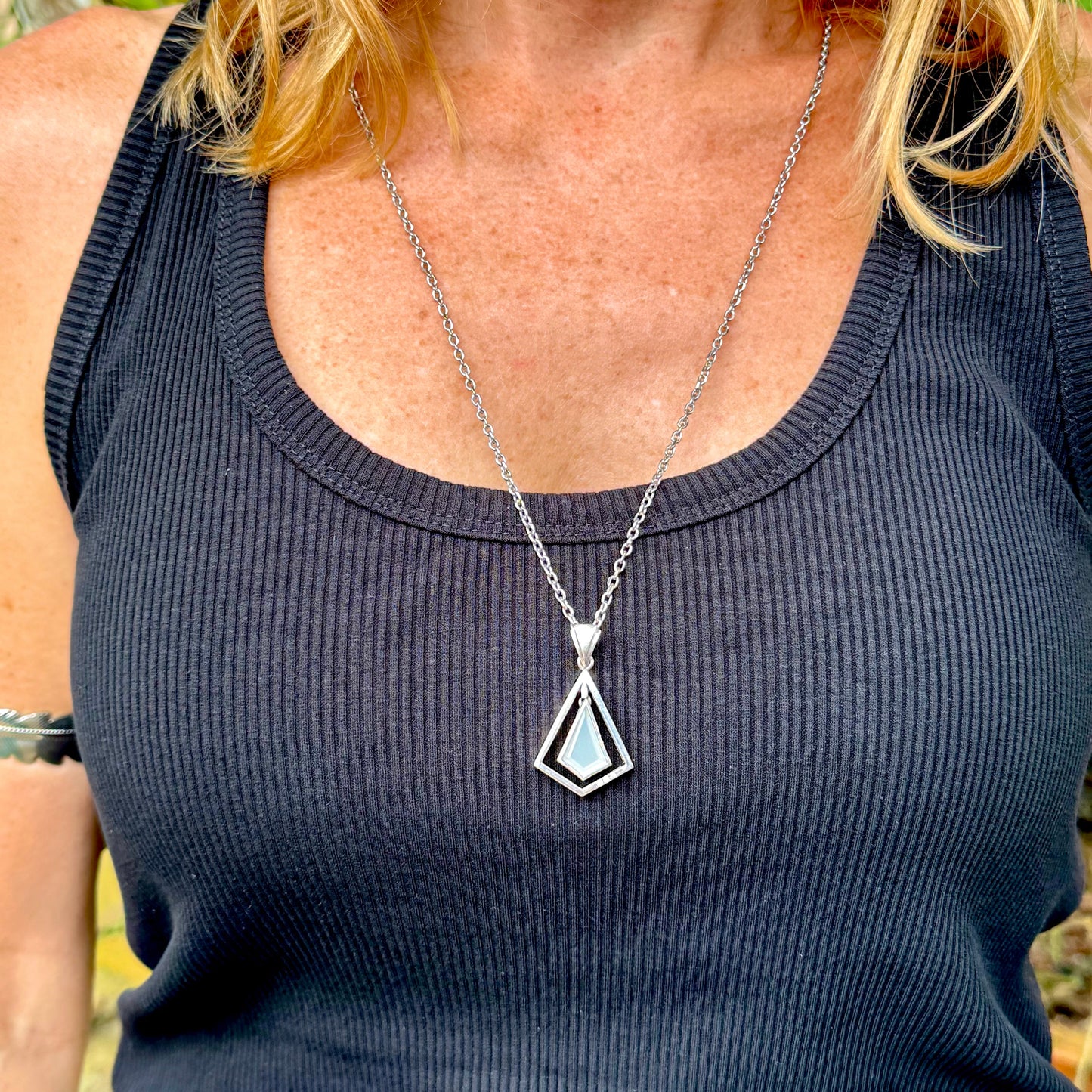 Handcrafted white gold-plated silver pendant with 4.04 ct moonstone and cubic zirconia accents in a geometric design.