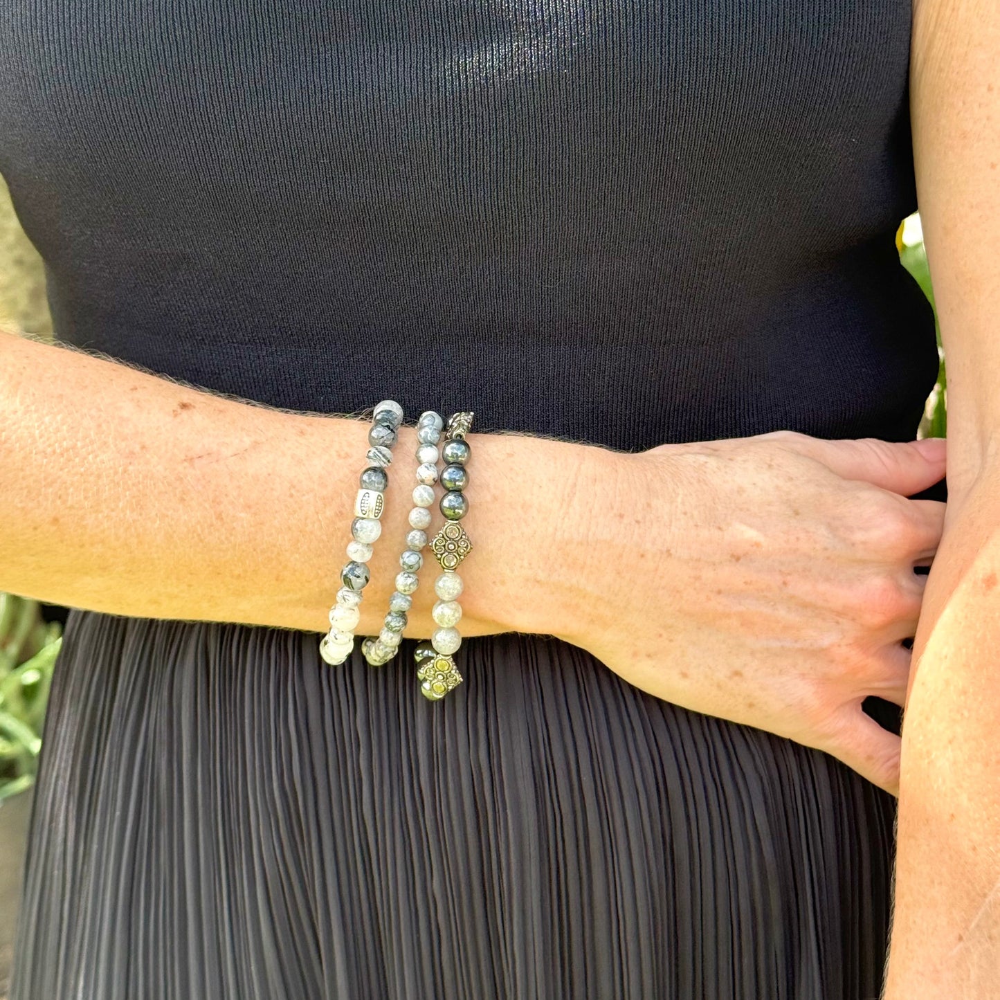 Rutilated quartz beaded bracelet, 18cm, black-white-grey gemstone beads with two decorated metal spacers on elastic band.