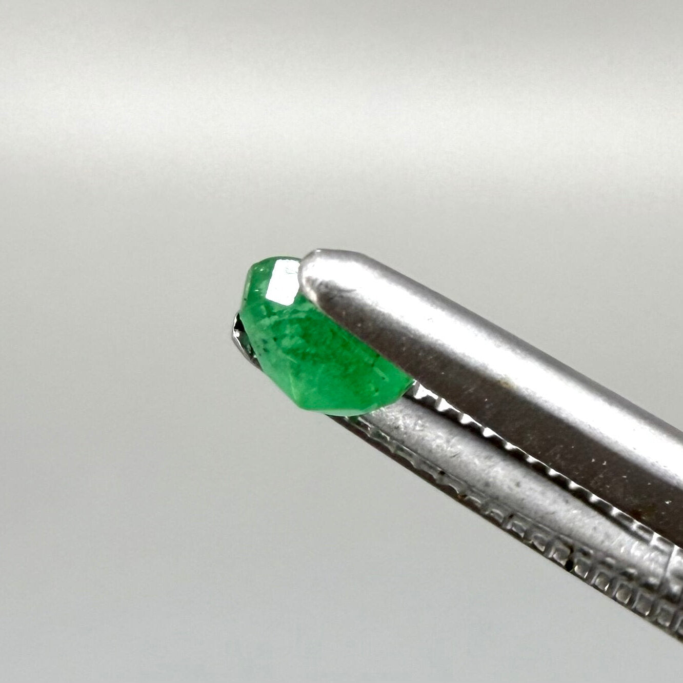 0.2 ct natural untreated Zambian emerald, oval faceted with bright bluish-green color.