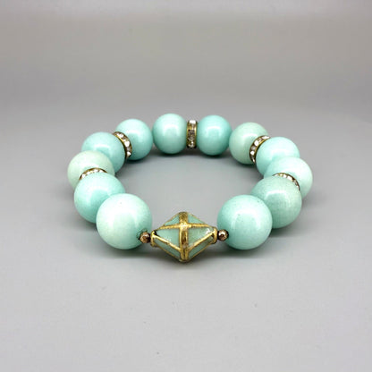 Larimar beaded bracelet, 18cm, aqua-blue gemstone beads with gold-toned spacers and decorative golden focal accent on elastic stretch band.