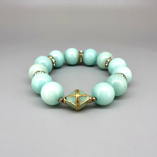 Larimar beaded bracelet, 18cm, aqua-blue gemstone beads with gold-toned spacers and decorative golden focal accent on elastic stretch band.
