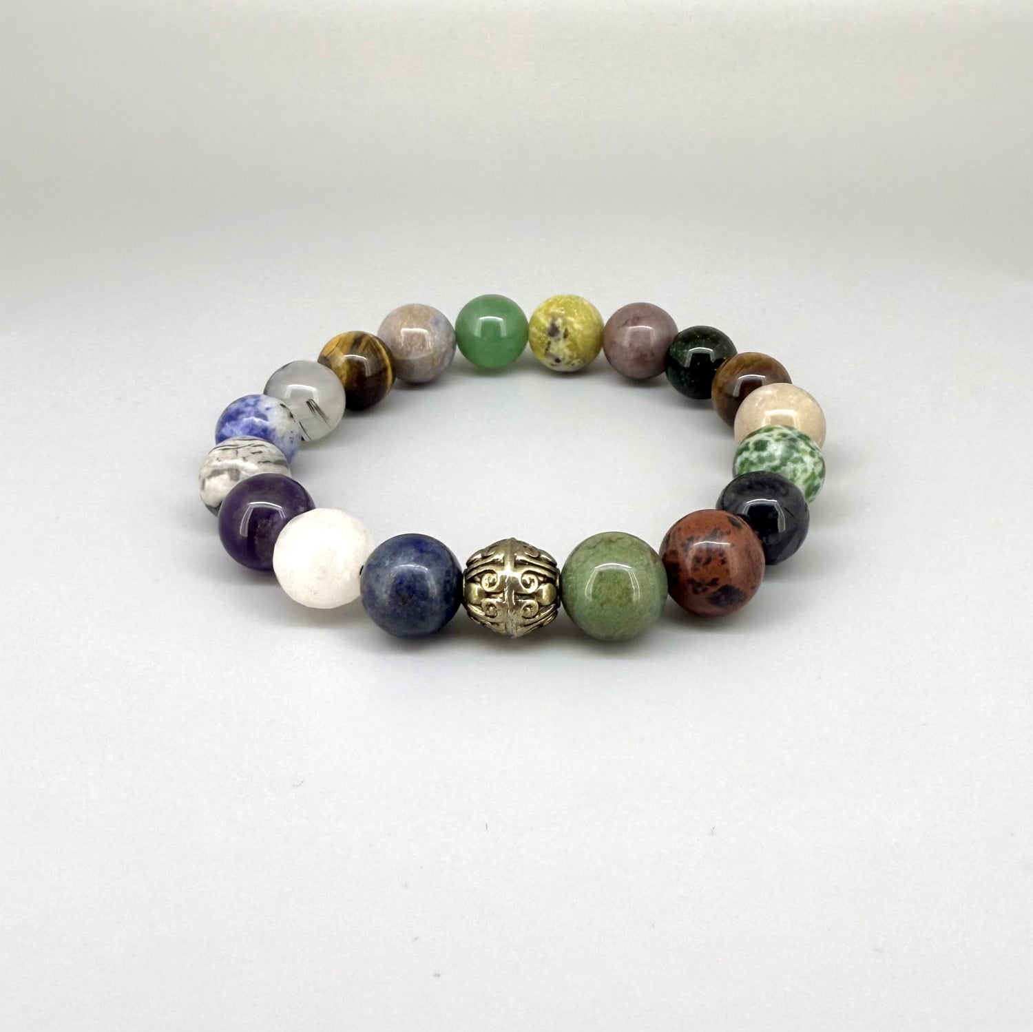 Multi-gemstone beaded bracelet, 18cm, with lapis lazuli, quartz, moonstone, amethyst, jasper, green fluorite, and rutilated quartz beads on elastic stretch band.
