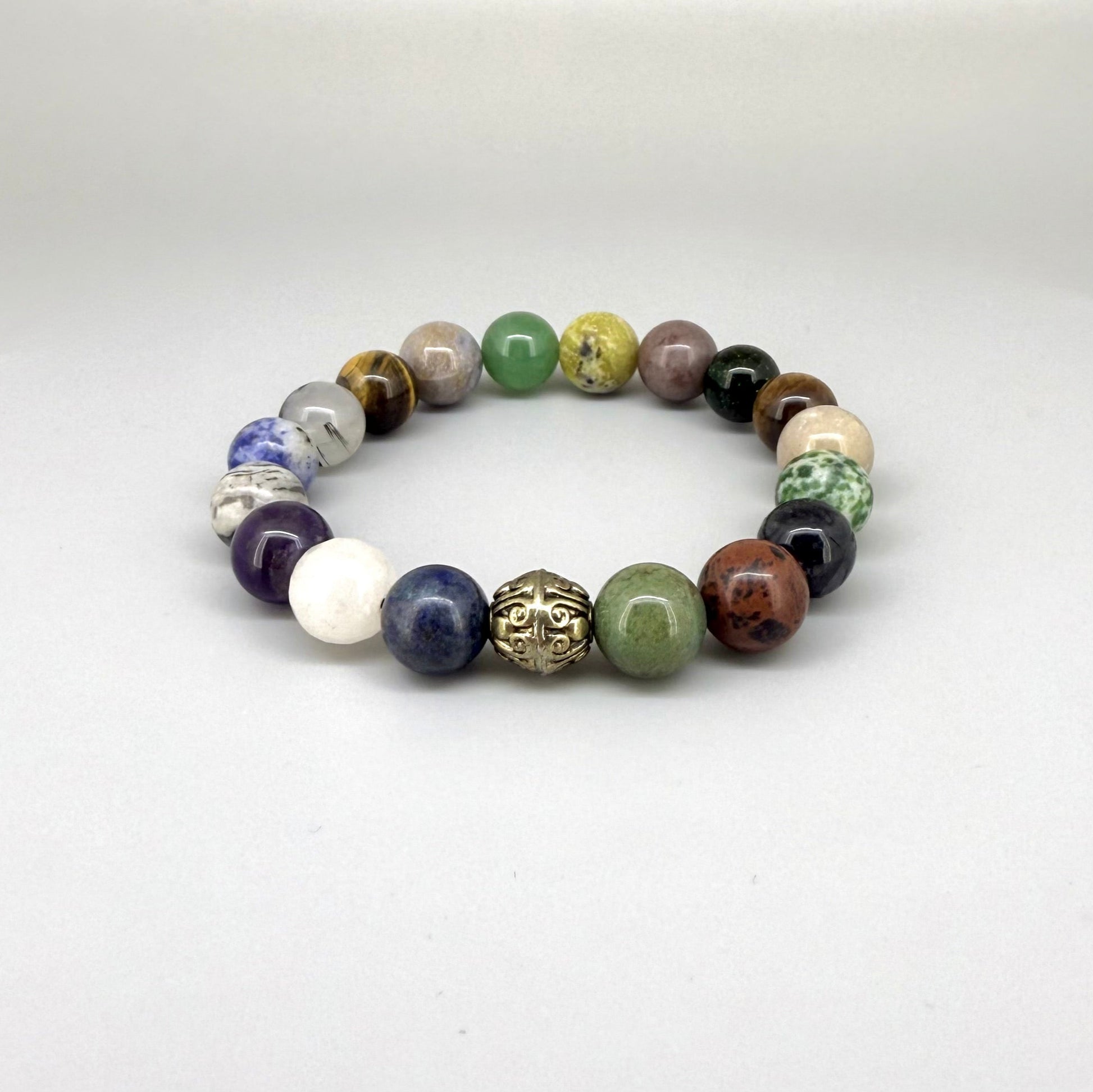 Multi-gemstone beaded bracelet, 18cm, with lapis lazuli, quartz, moonstone, amethyst, jasper, green fluorite, and rutilated quartz beads on elastic stretch band.