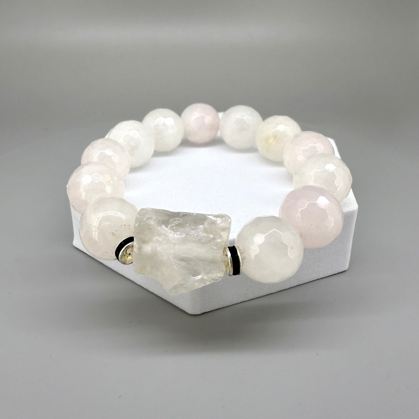 Rose quartz beaded bracelet, 18cm, light pink gemstone beads with larger clear accent stone on elastic stretch band.