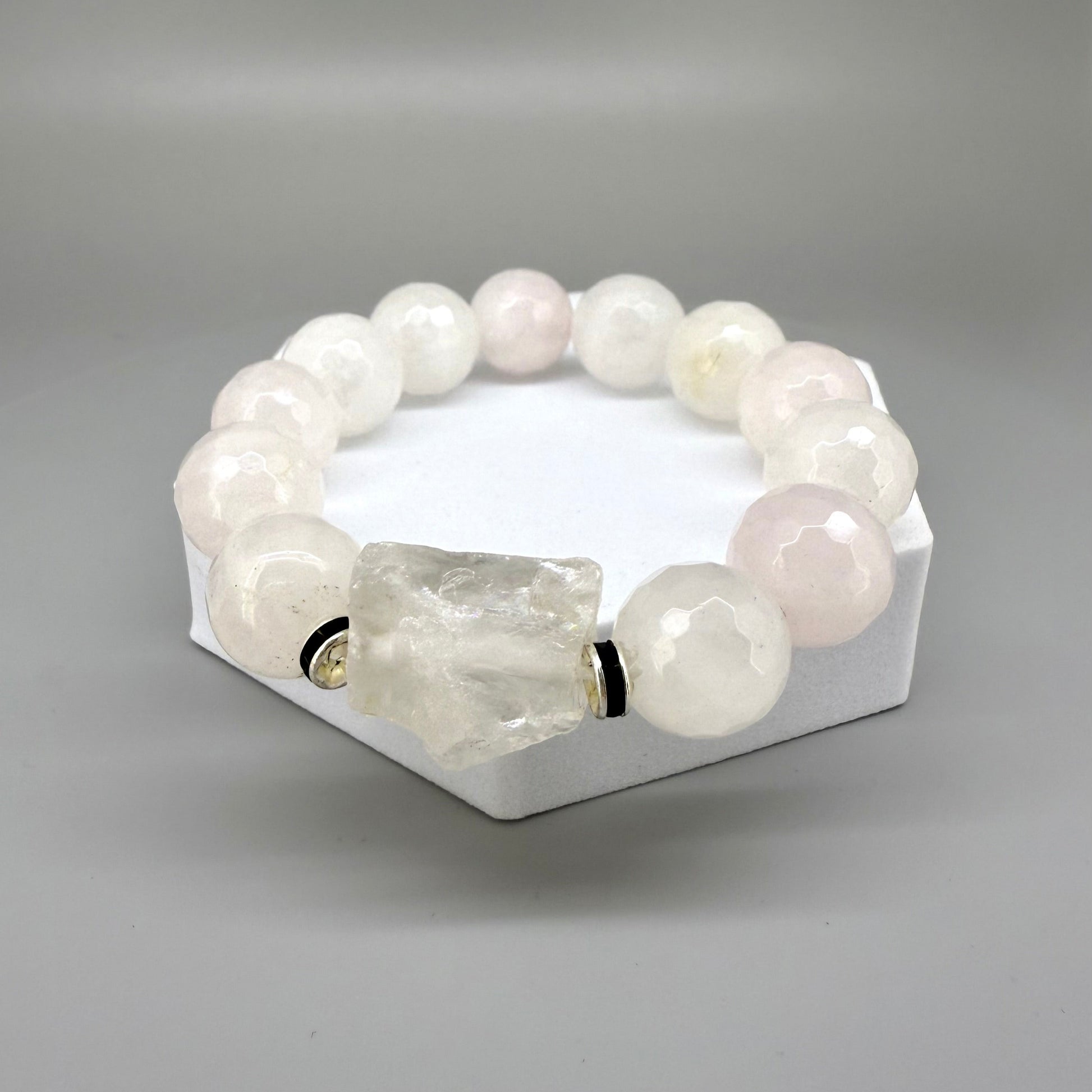 Rose quartz beaded bracelet, 18cm, light pink gemstone beads with larger clear accent stone on elastic stretch band.