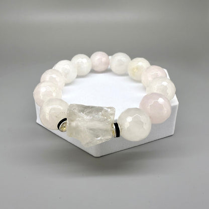 Rose quartz beaded bracelet, 18cm, light pink gemstone beads with larger clear accent stone on elastic stretch band.