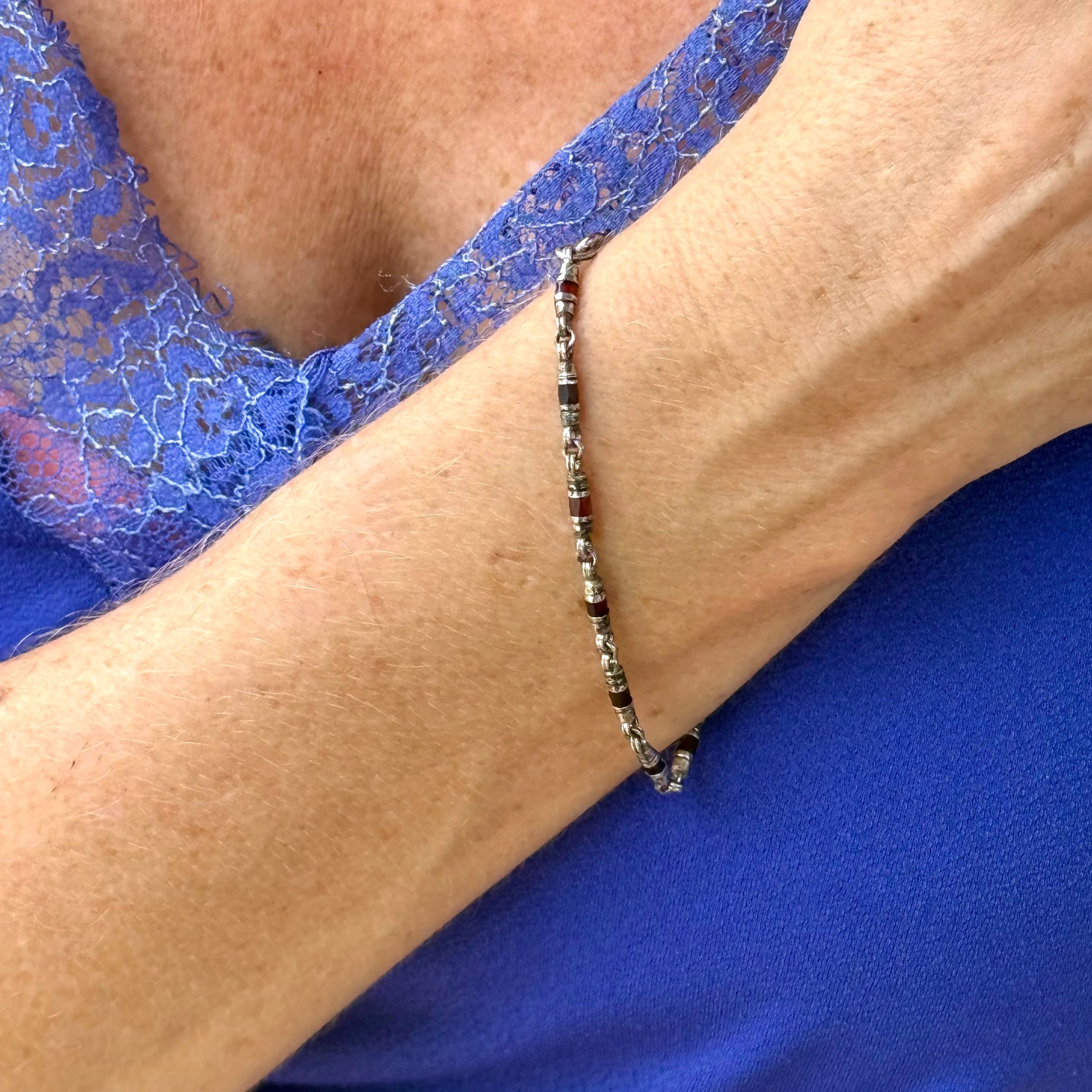 Garnet Pyrope bracelet in sterling silver with white gold plating, elegant design on neutral background