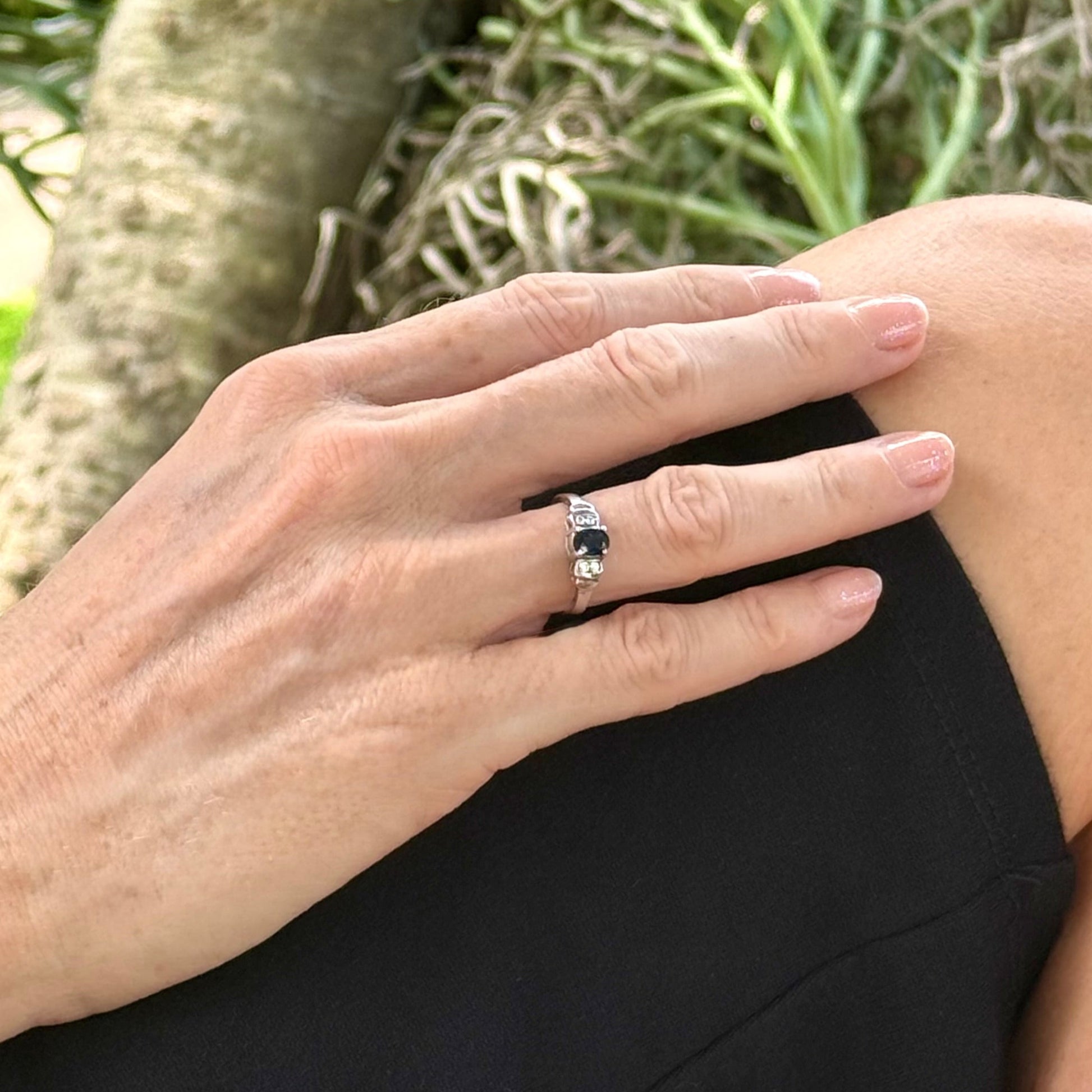Sapphire and CZ ring in white gold plated sterling silver on neutral background