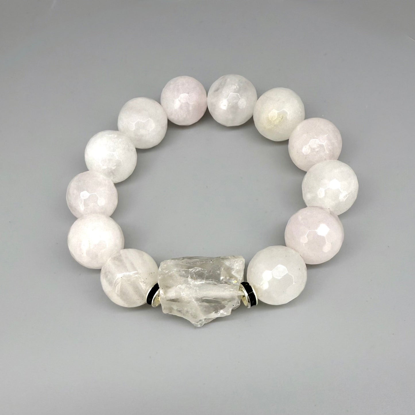 Rose quartz beaded bracelet, 18cm, light pink gemstone beads with larger clear accent stone on elastic stretch band.