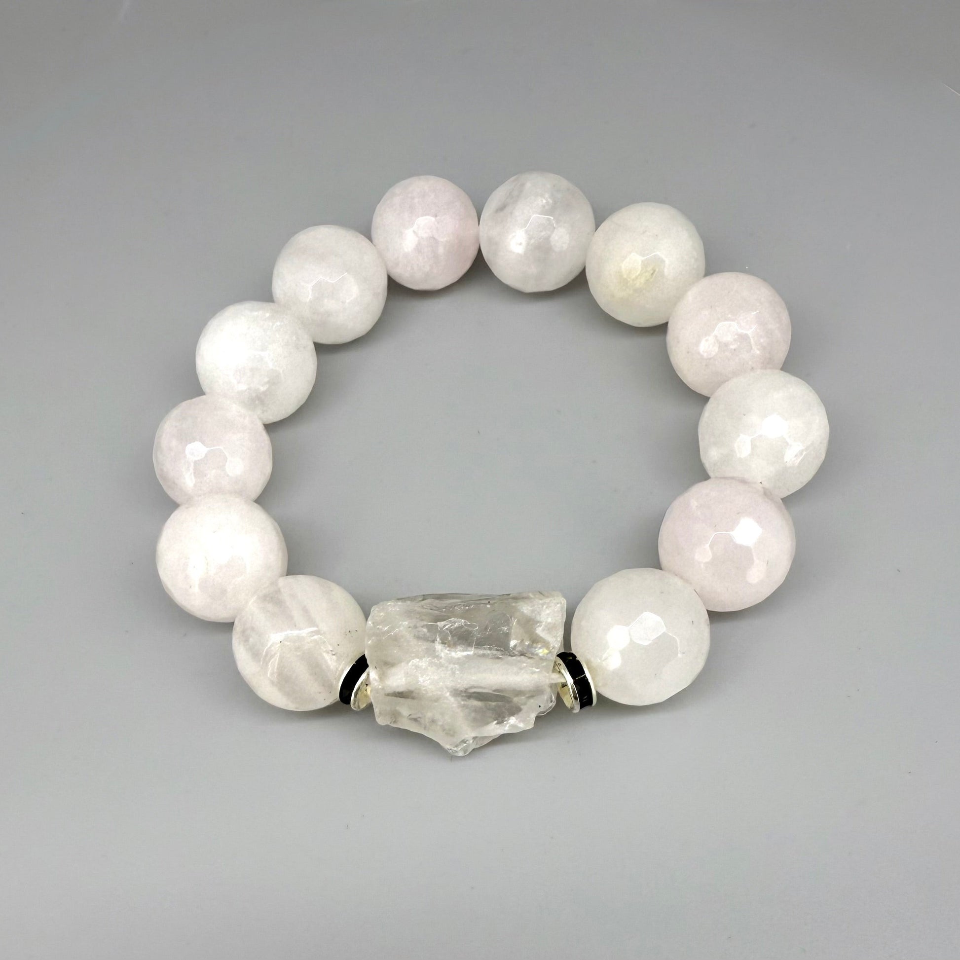 Rose quartz beaded bracelet, 18cm, light pink gemstone beads with larger clear accent stone on elastic stretch band.