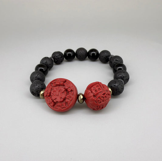 Lava and cinnabar-style beaded bracelet, 18cm, black lava beads with two carved red resin accent beads on elastic stretch band.