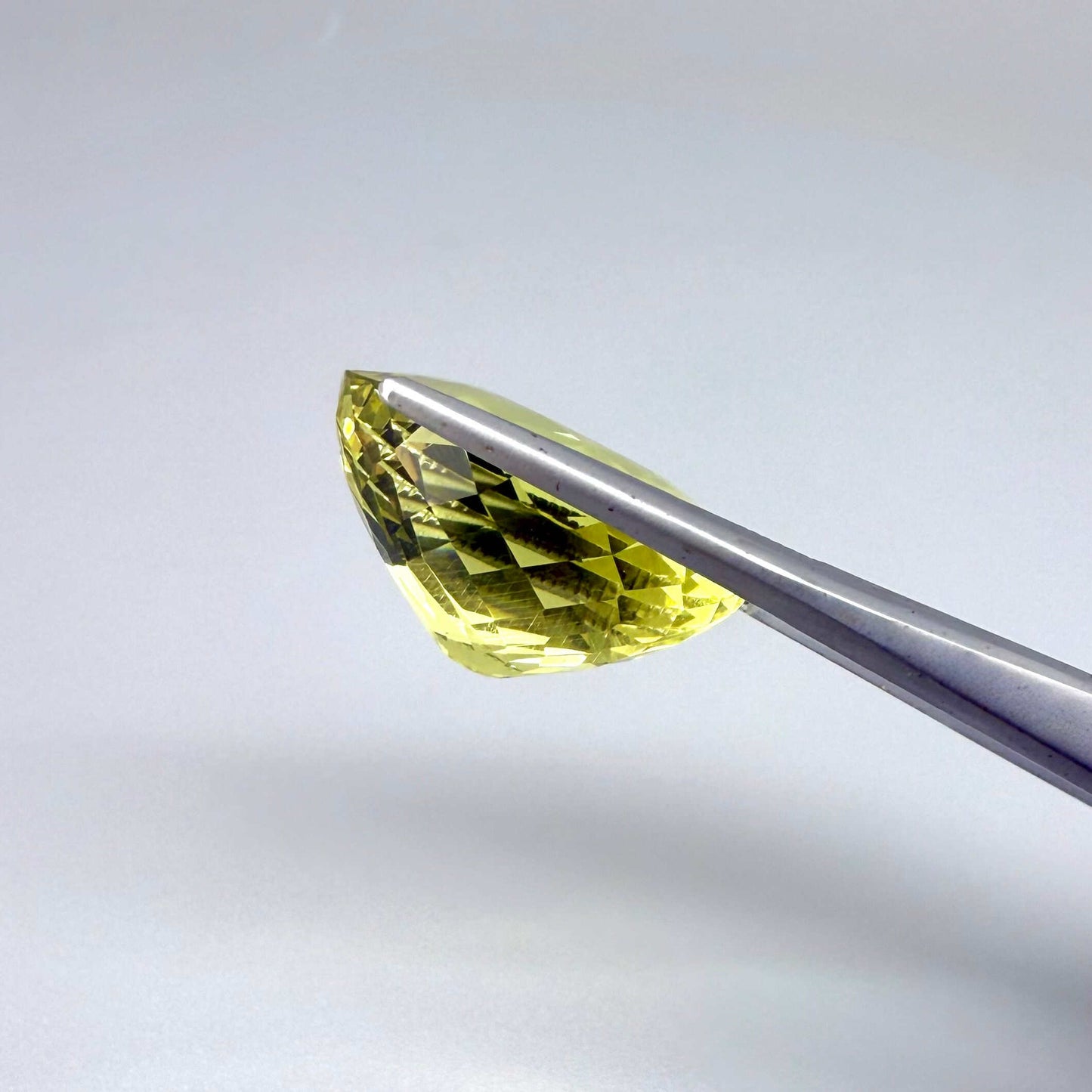 28.09 ct natural lemon quartz from Africa, oval cut with bright yellow color.