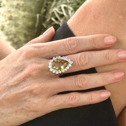 Citrine and CZ ring in white gold plated sterling silver, featuring a pear-shaped golden-yellow gemstone surrounded by clear cubic zirconia halo, elegant and refined design