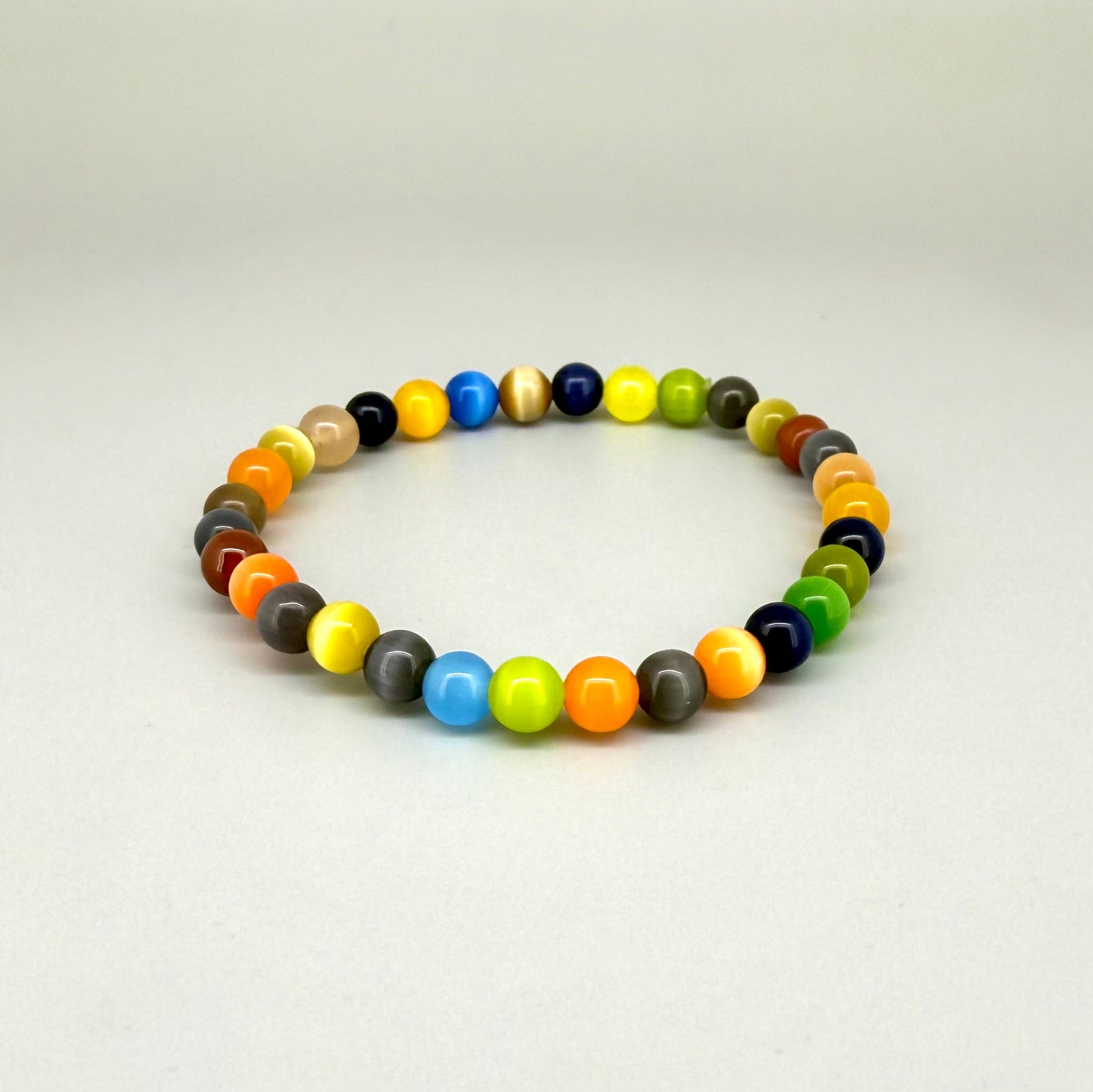 Multicolor cat’s eye beaded bracelet, 18cm, vivid gemstone beads in bright, brown, and black tones with shimmering effect on elastic stretch band.
